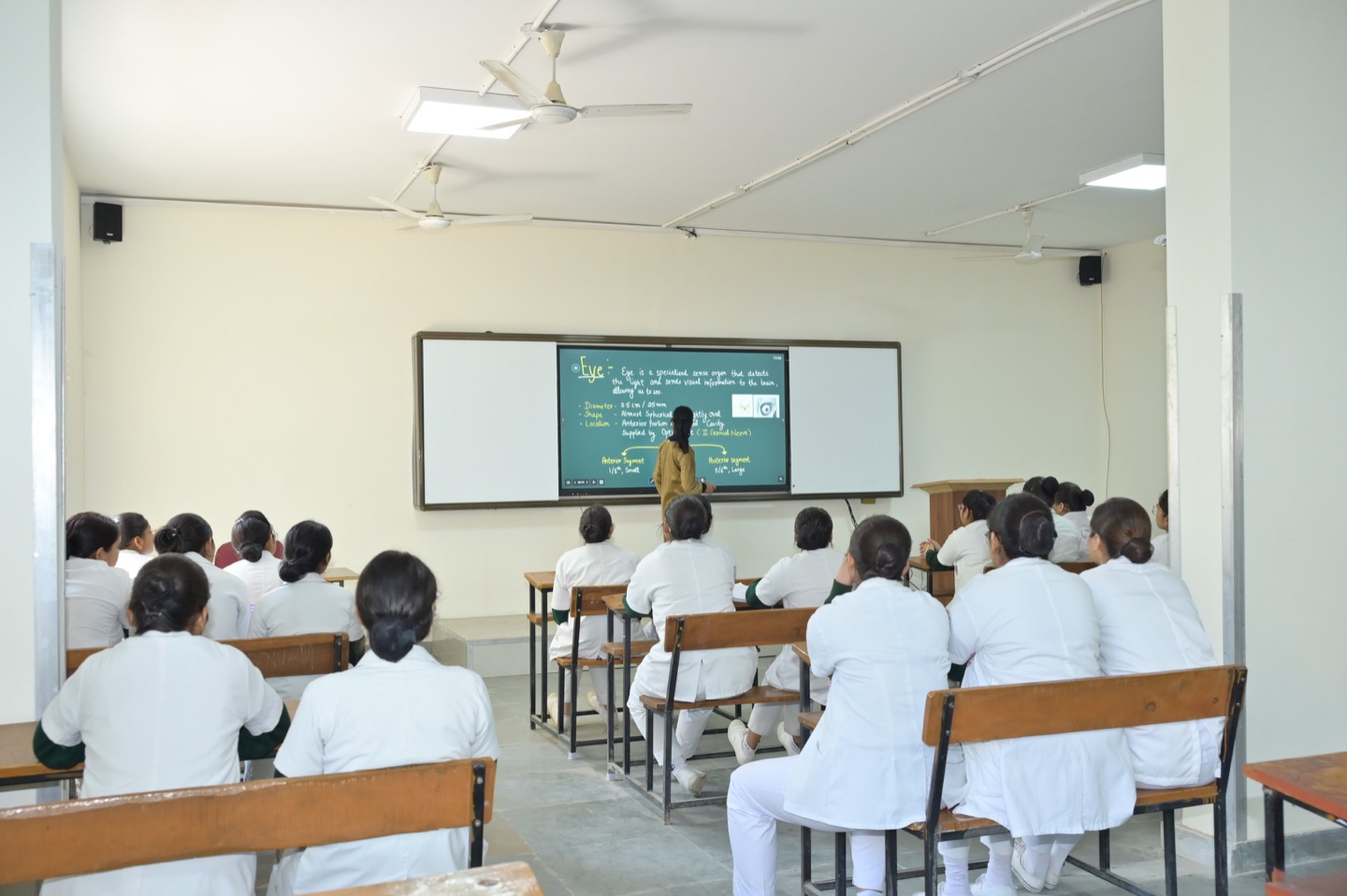 Students learning with a digital teaching board in a shared campus classroom